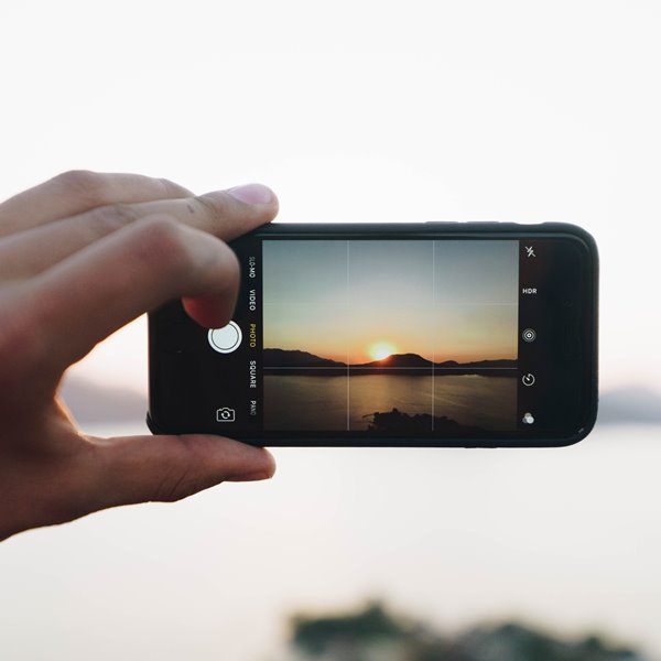 cell phone camera taking a photo of a sunset