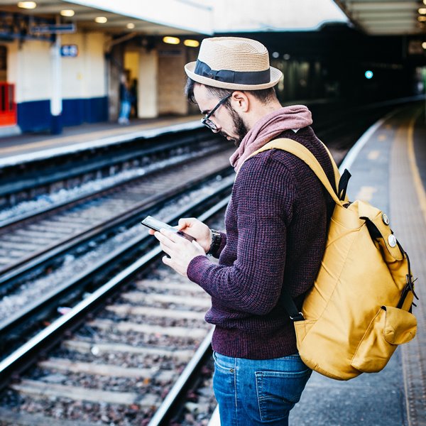 man on cell phone near train tracks