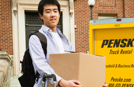 Man moving boxes out of Penske truck