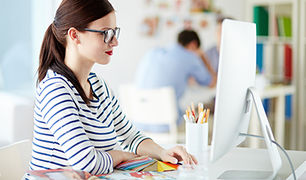 Young girl looking up discounts on computer