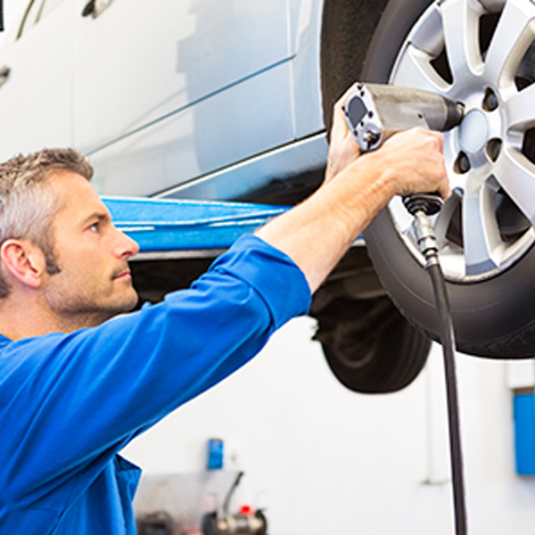 Mechanic working on a tire on a vehicle 