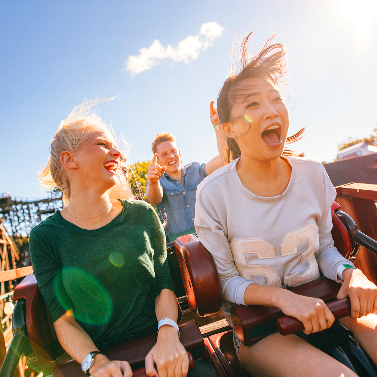 Two people riding on a rollercoaster who took advantage of AAA discounts on Theme Park admission