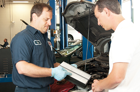 AAA Car Care Plus Mechanic reviewing a repair with a AAA member