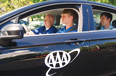 Two teenagers in a car with an AAA Driver Training instructor