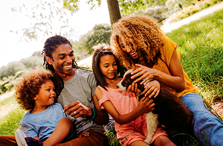 A family of four with bonding with their puppy