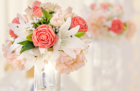 A bouquet of pink and white flowers displayed in a mason jar