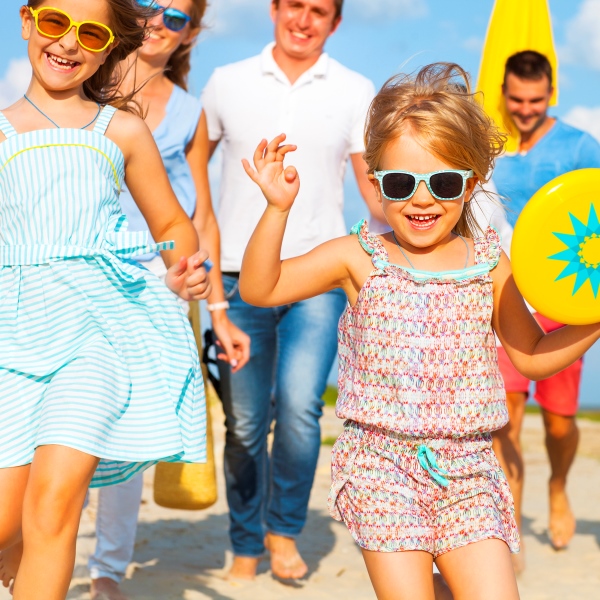 family running on beach