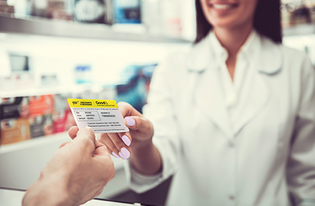 AAA Member giving pharmacist a GoodRx card