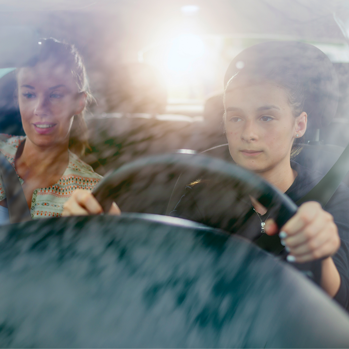Teen driving with mother 