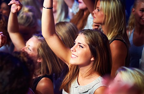 group enjoying concert focus on one woman
