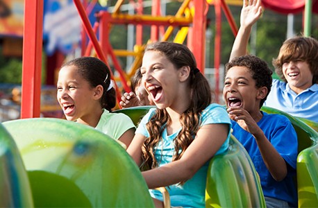 Cedar Point children riding thrilling roller coaster