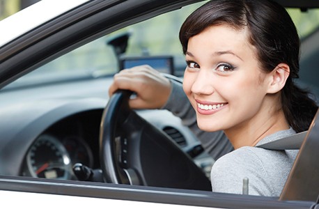 smiling woman driving car