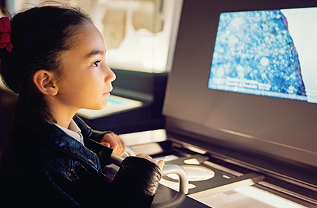 girl looking at science exhibit