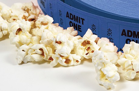 A roll of tickets surrounded by popcorn