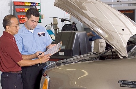 AAA Approved Auto Repair tech explaining a repair to a AAA member