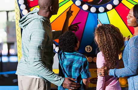 Family of four playing a game at a fun house