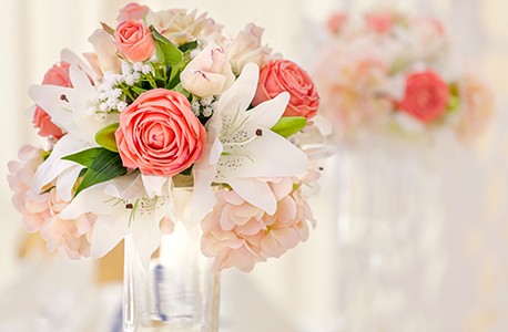 A bouquet of pink and white flowers displayed in a mason jar