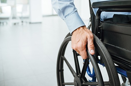 A close up of an individual using a wheelchair