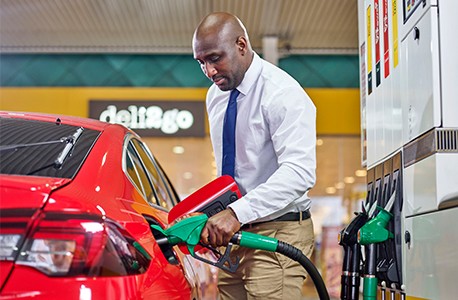 Businessman pumping fuel at Shell